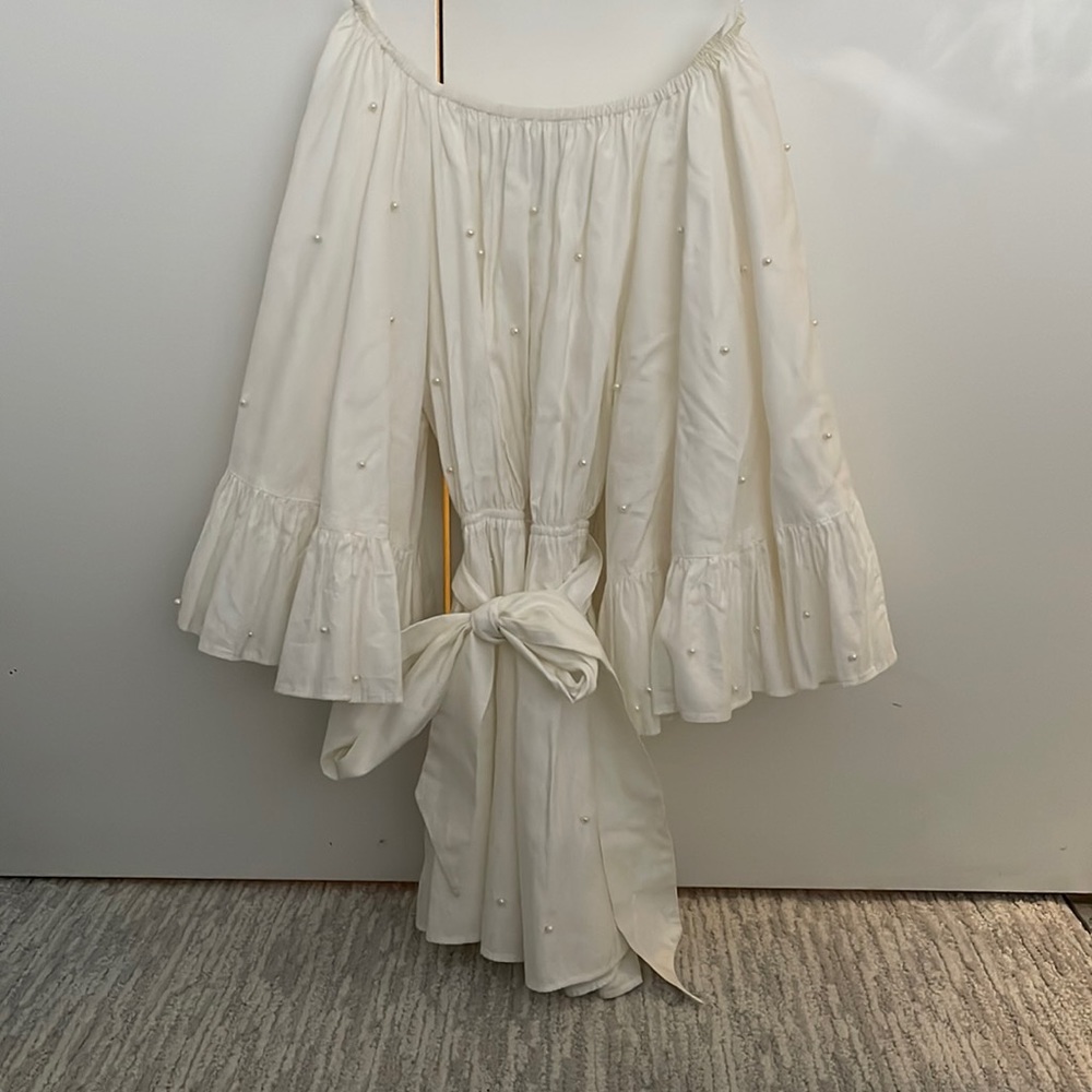 Beautiful designer romper with pearl details.